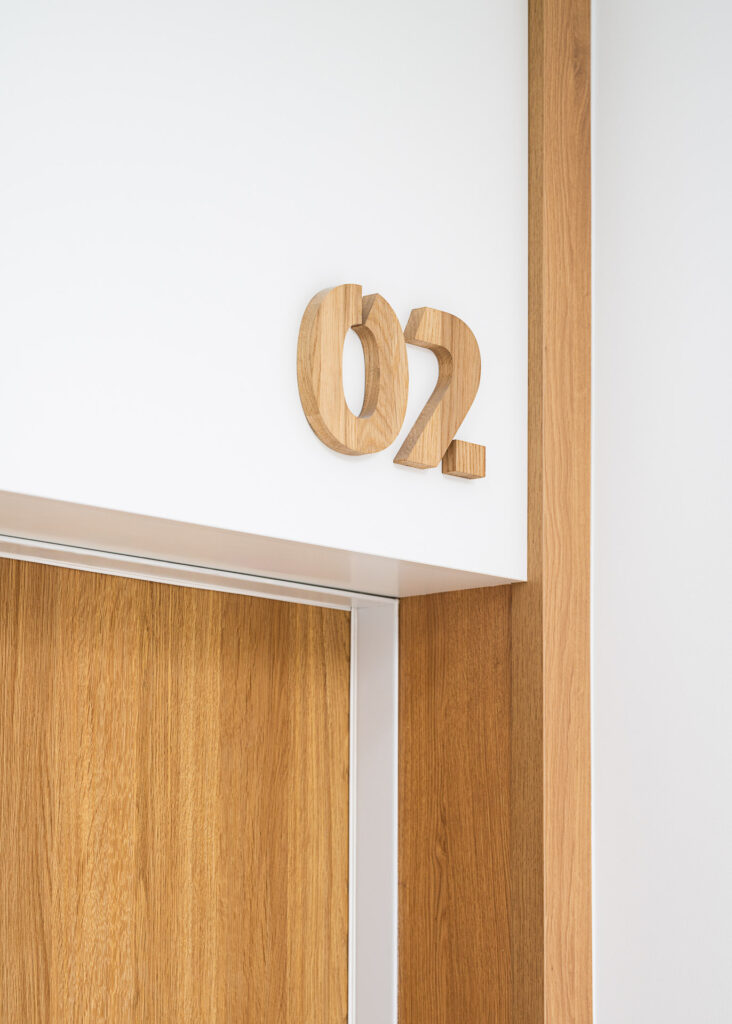 Wooden apartment number wayfinding system