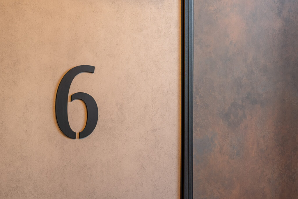 Doki Living Gdansk residential building apartment number signage