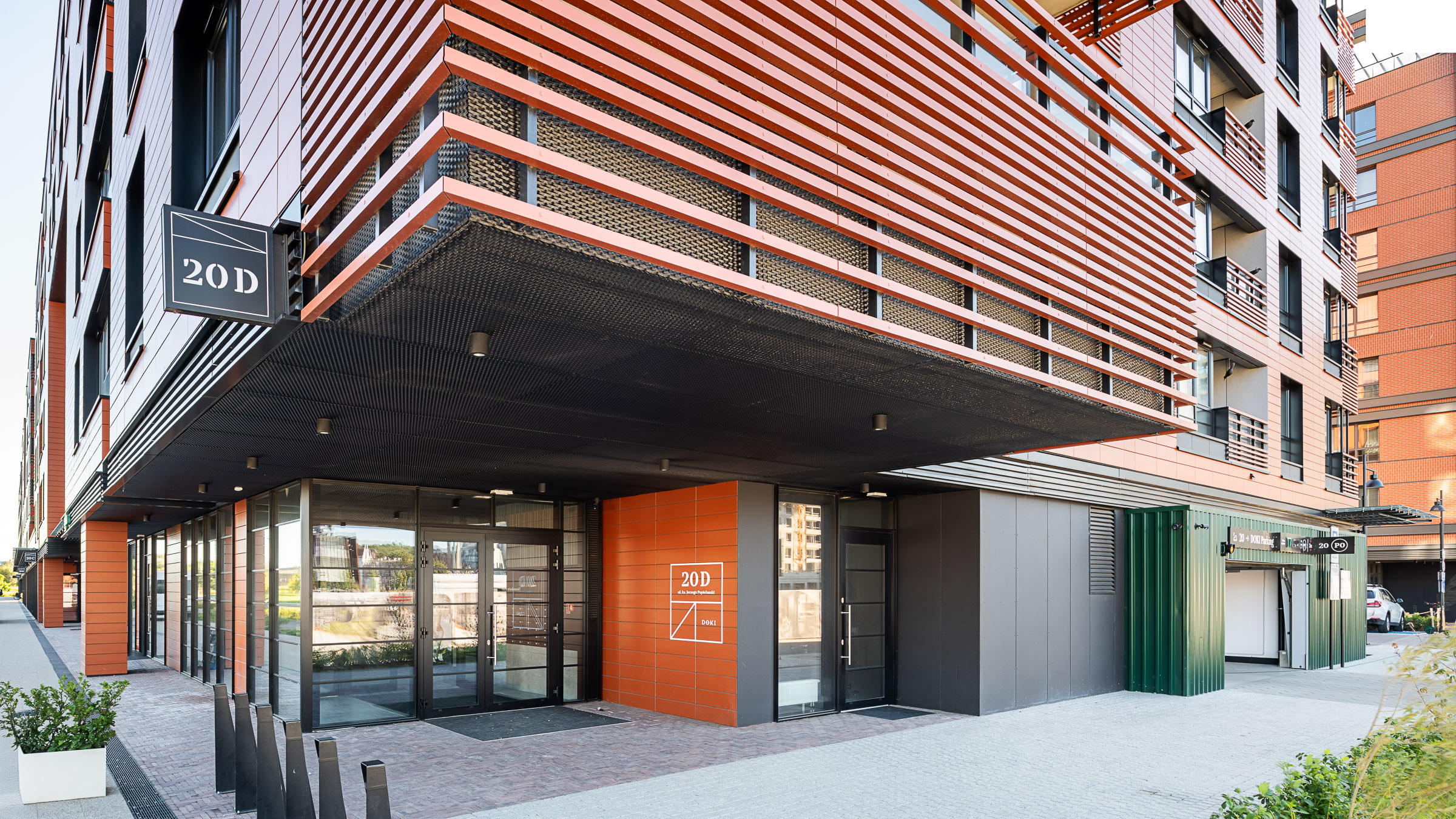 Doki Living Gdansk residential building entrance signage with address