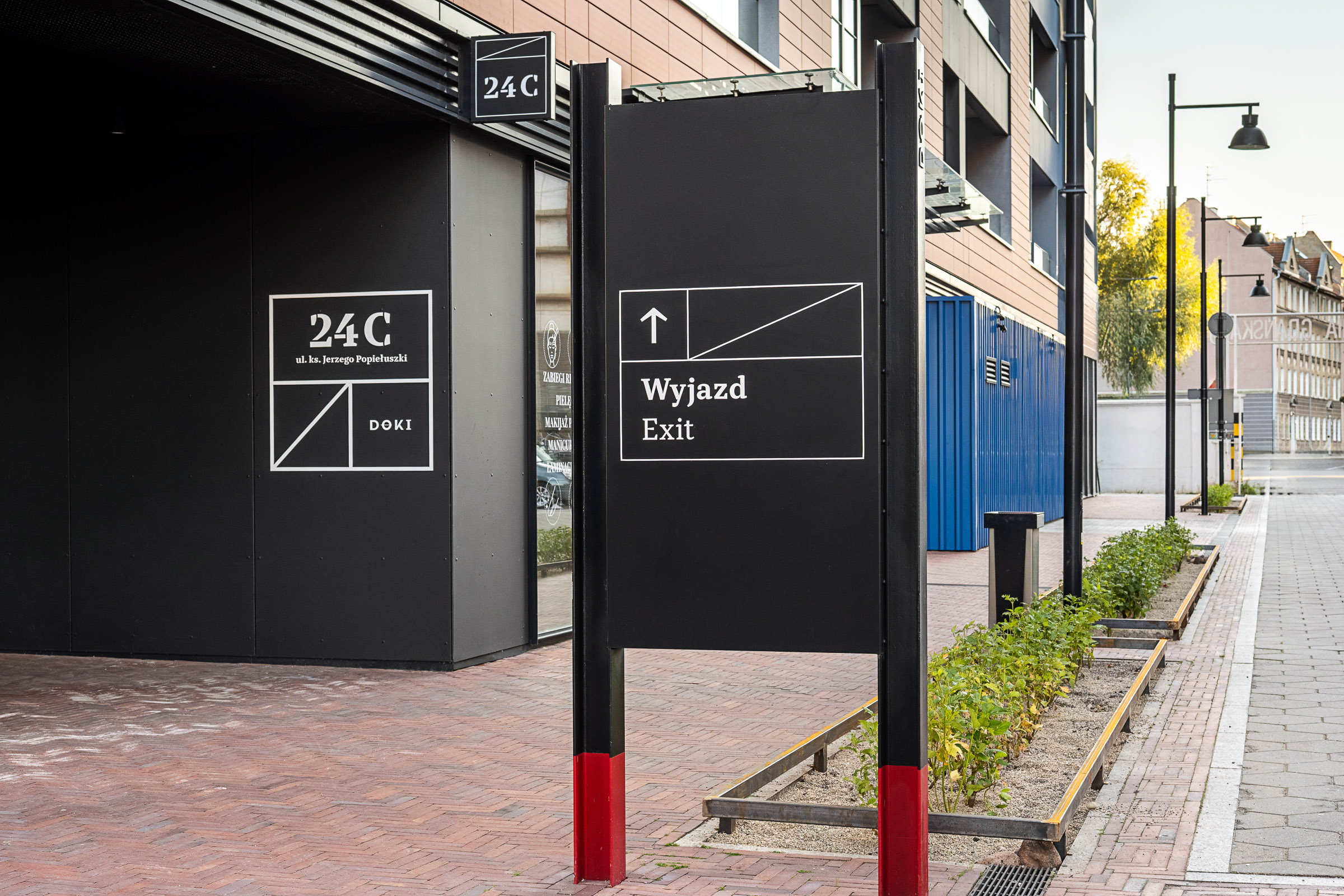 Doki Living Gdansk residential building totem signage design