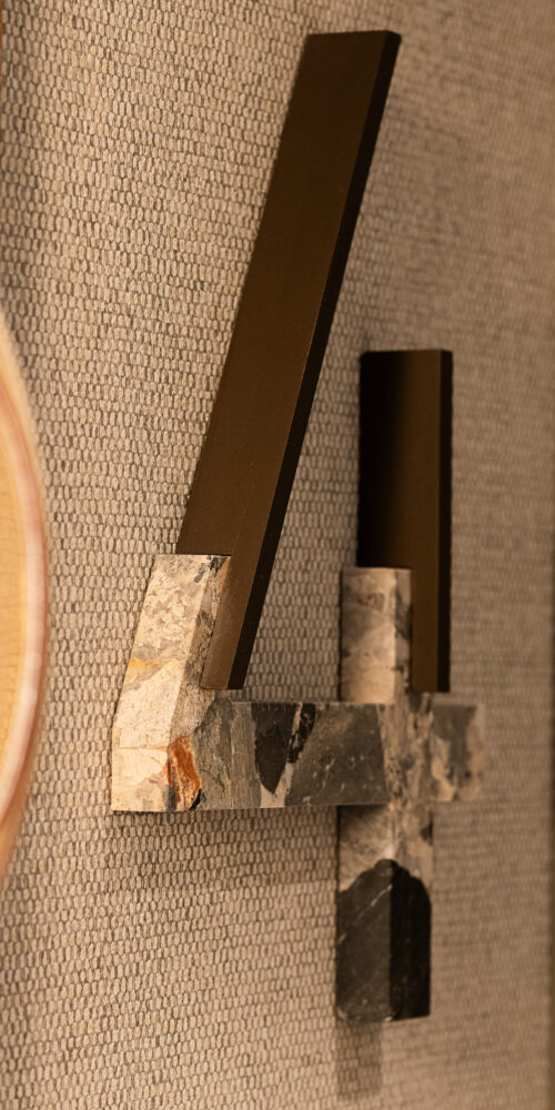 Close-up of a metal and stone wayfinding sign floor number wayfinding Lindego Noho